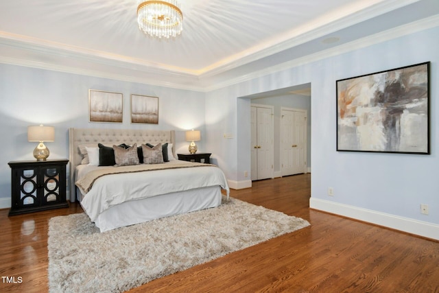 5204 Winter Holly Ct, Raleigh, NC 27606 - bedroom with wood finished floors, a chandelier, crown molding, and a tray ceiling