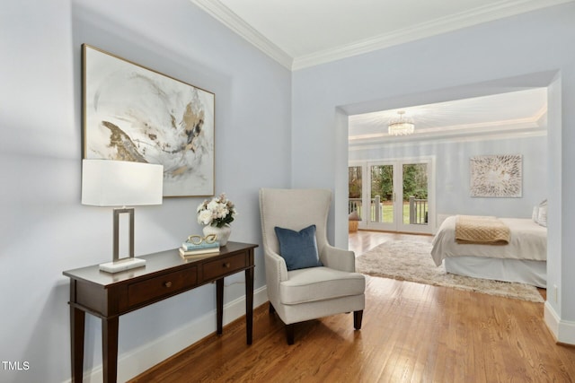 5204 Winter Holly Ct, Raleigh, NC 27606 - bedroom featuring wood finished floors, ornamental molding, access to outside, and a chandelier