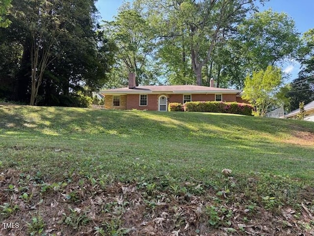 2705 Royster St, Raleigh, NC 27608 - view of front of home featuring a chimney and a front lawn