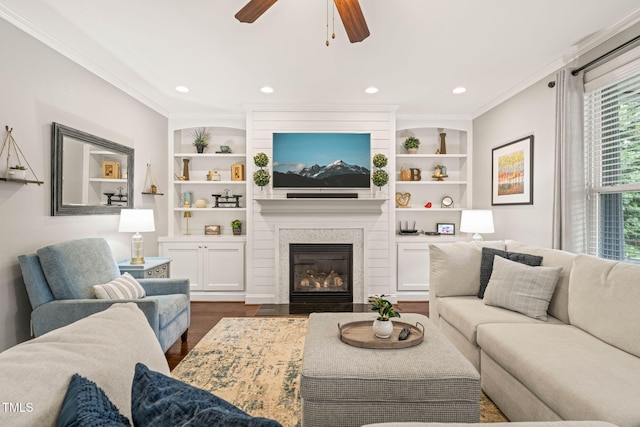 508 Morning Oaks Dr, Holly Springs, NC 27540 - living area with dark wood finished floors, ceiling fan, ornamental molding, built in shelves, and a large fireplace