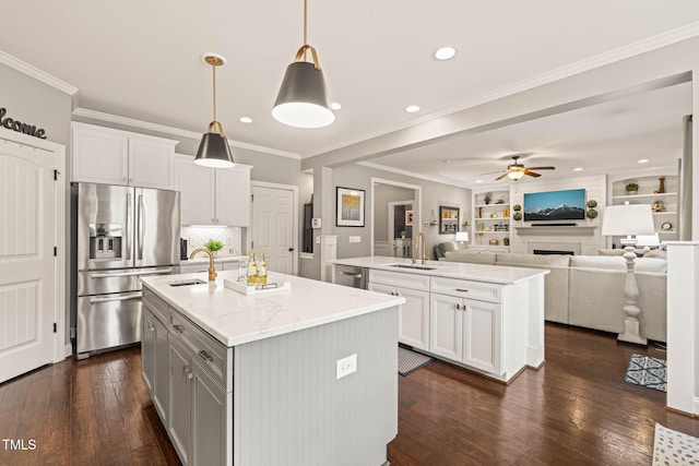 508 Morning Oaks Dr, Holly Springs, NC 27540 - kitchen with appliances with stainless steel finishes, an island with sink, ceiling fan, dark wood finished floors, and white cabinets