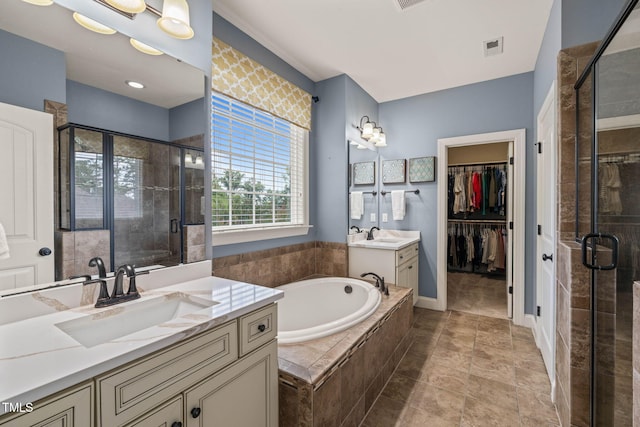 508 Morning Oaks Dr, Holly Springs, NC 27540 - bathroom featuring two vanities, a shower stall, a bath, and a spacious closet