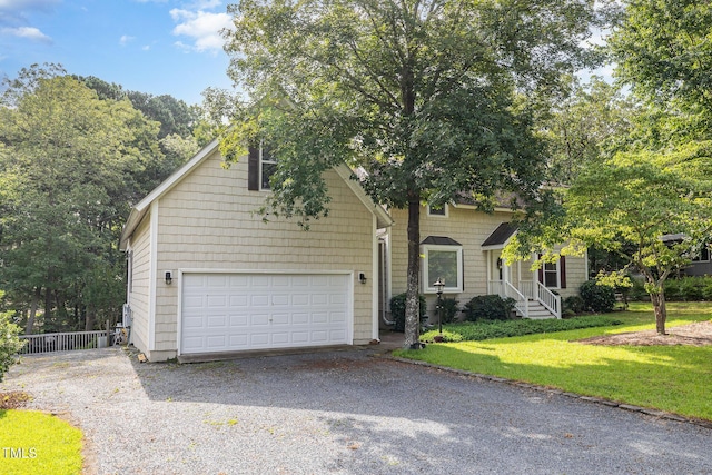 106 Scuppernong Ct, West End, NC 27376 - obstructed view of property with driveway and a garage