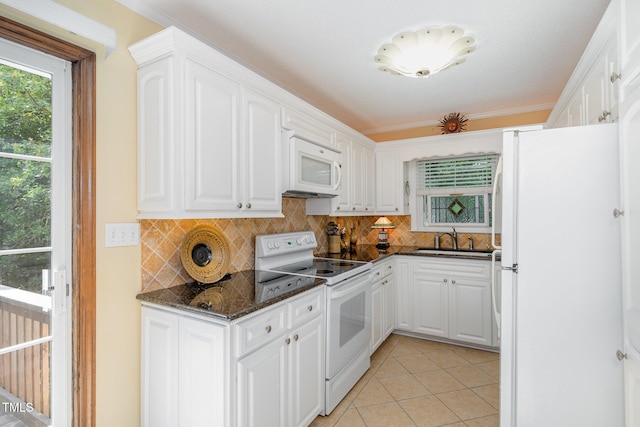 106 Scuppernong Ct, West End, NC 27376 - kitchen featuring white appliances, white cabinets, tasteful backsplash, and dark stone counters