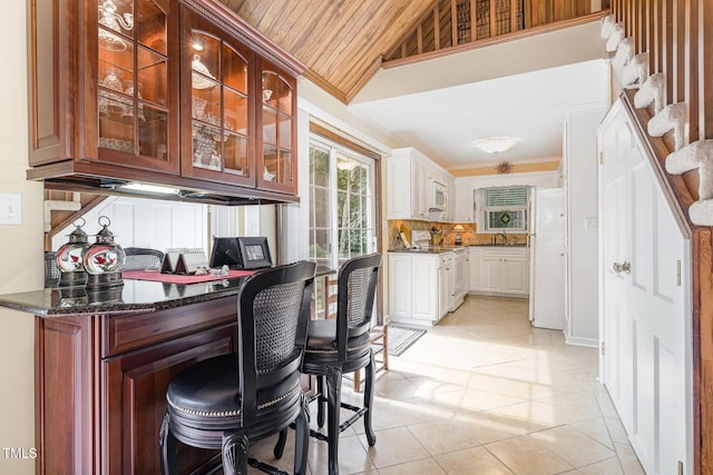 106 Scuppernong Ct, West End, NC 27376 - bar with white appliances, vaulted ceiling, light tile patterned floors, stairs, and ornamental molding