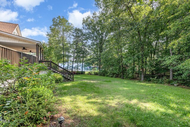 106 Scuppernong Ct, West End, NC 27376 - view of grassy yard with a ceiling fan and stairway