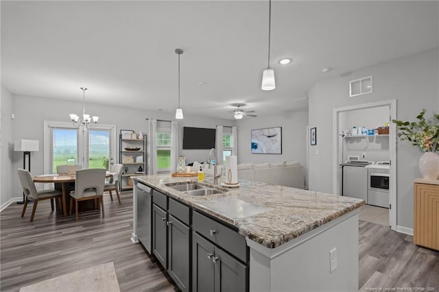 115 Doubletree Ln, Autryville, NC 28318 - kitchen with stainless steel dishwasher, light wood finished floors, light stone countertops, a chandelier, and recessed lighting