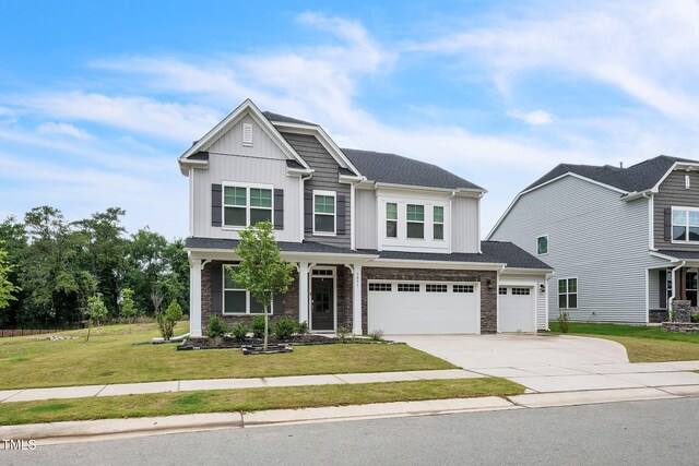 1051 Jura Ridge Dr, Fuquay Varina, NC 27526 - craftsman house with driveway, a front yard, board and batten siding, and stone siding