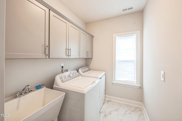 1051 Jura Ridge Dr, Fuquay Varina, NC 27526 - laundry area featuring washer and dryer, cabinet space, and light marble finish floors