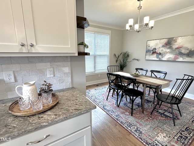 118 Chestnut St, Durham, NC 27707 - dining space featuring crown molding, wood finished floors, and a chandelier