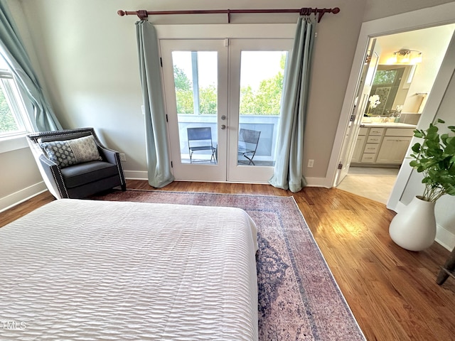 118 Chestnut St, Durham, NC 27707 - bedroom with access to exterior, light wood-style floors, connected bathroom, and french doors