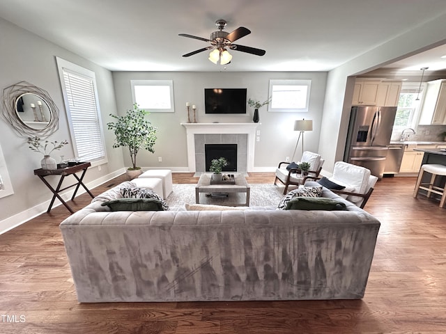 118 Chestnut St, Durham, NC 27707 - living area with a tile fireplace, a ceiling fan, and wood finished floors