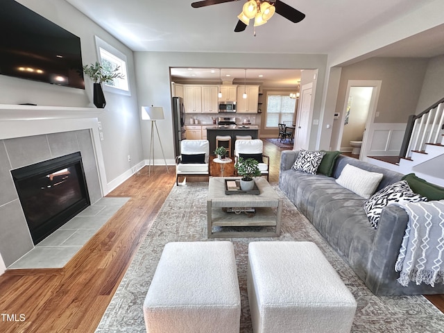 118 Chestnut St, Durham, NC 27707 - living area featuring ceiling fan, stairway, light wood-style flooring, and a tile fireplace