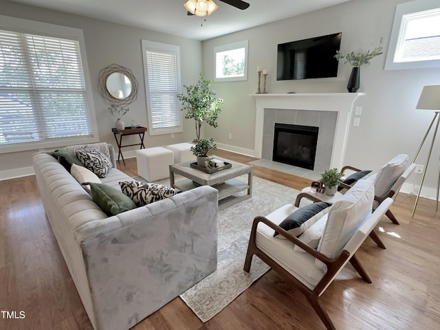 118 Chestnut St, Durham, NC 27707 - living room featuring wood finished floors, a tile fireplace, and a ceiling fan