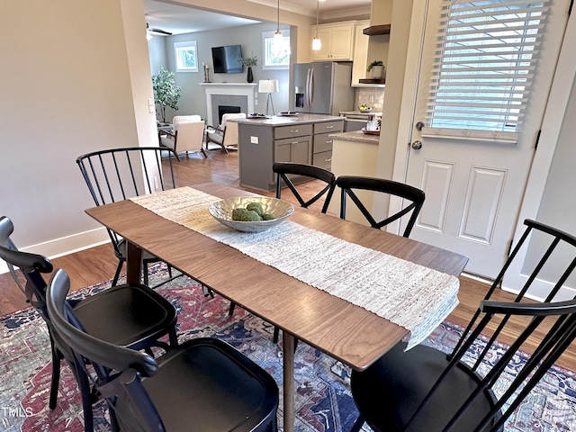 118 Chestnut St, Durham, NC 27707 - dining area with a fireplace and wood finished floors