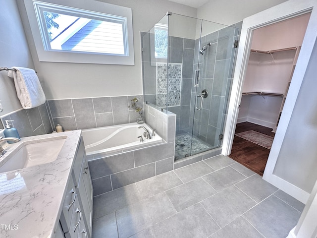118 Chestnut St, Durham, NC 27707 - full bathroom featuring a bath, a stall shower, tile patterned floors, vanity, and a walk in closet