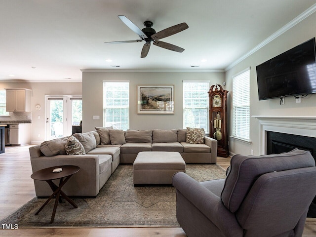 857 Stable Fern Dr, Fuquay Varina, NC 27526 - living room with a fireplace, light wood-type flooring, a ceiling fan, crown molding, and recessed lighting