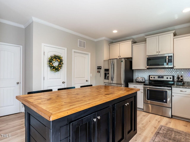 857 Stable Fern Dr, Fuquay Varina, NC 27526 - kitchen featuring stainless steel appliances, butcher block countertops, ornamental molding, light wood finished floors, and tasteful backsplash