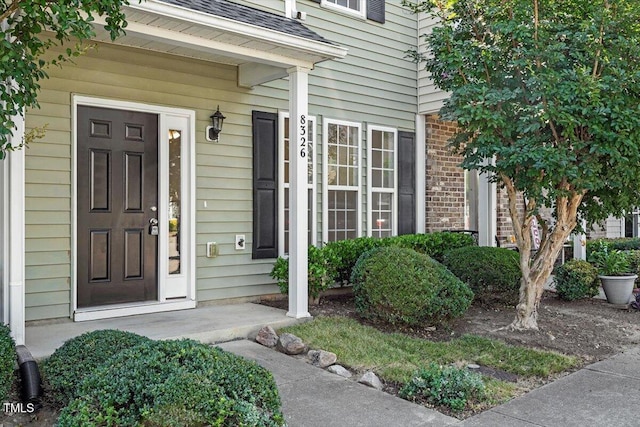 8326 Glenwood Springs Ct, Raleigh, NC 27616 - property entrance featuring brick siding and roof with shingles