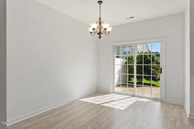 8326 Glenwood Springs Ct, Raleigh, NC 27616 - spare room with a chandelier and light wood finished floors