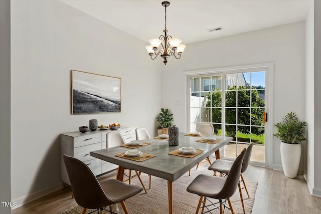 8326 Glenwood Springs Ct, Raleigh, NC 27616 - dining area with a chandelier and light wood-style flooring