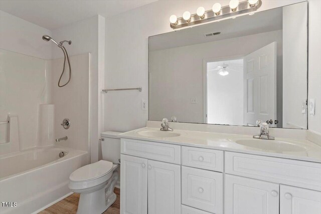 8326 Glenwood Springs Ct, Raleigh, NC 27616 - bathroom with double vanity, shower / washtub combination, wood finished floors, and ceiling fan