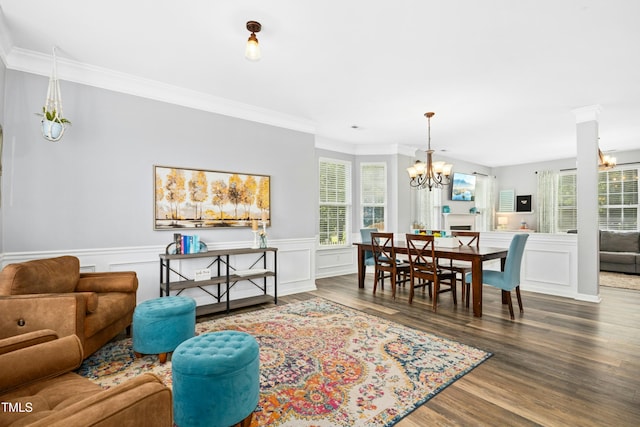 304 Forbes Rd, Wake Forest, NC 27587 - living room with a chandelier, ornamental molding, wood finished floors, healthy amount of natural light, and a wainscoted wall
