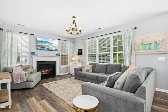 304 Forbes Rd, Wake Forest, NC 27587 - living area featuring a chandelier, dark wood-style flooring, and a fireplace with flush hearth
