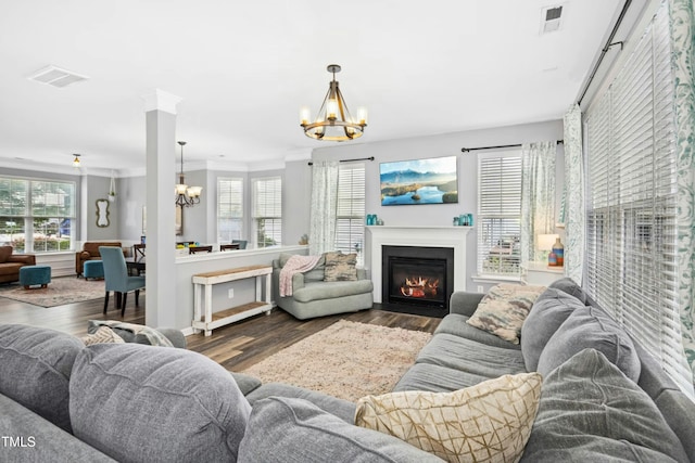 304 Forbes Rd, Wake Forest, NC 27587 - living area with a chandelier, wood finished floors, a fireplace with flush hearth, and crown molding