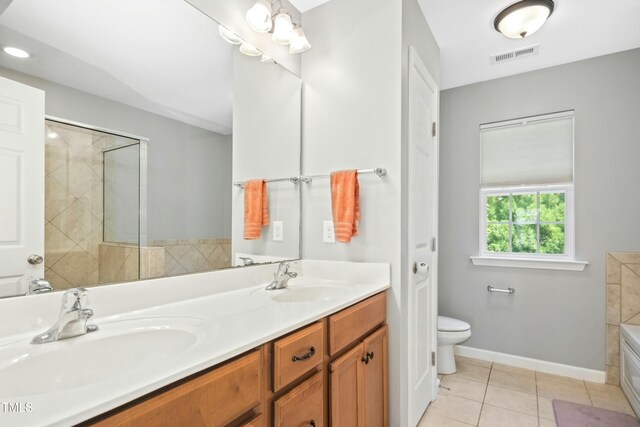 304 Forbes Rd, Wake Forest, NC 27587 - full bathroom featuring double vanity, tile patterned floors, and a tub