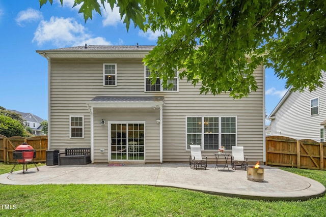 304 Forbes Rd, Wake Forest, NC 27587 - rear view of property featuring a fire pit, a patio area, a fenced backyard, and a gate