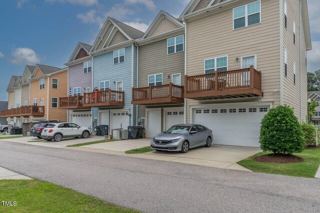 996 Tender Dr, Apex, NC 27502 - back of property with a garage, driveway, and a residential view