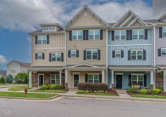 996 Tender Dr, Apex, NC 27502 - view of front of house with board and batten siding, stone siding, and covered porch