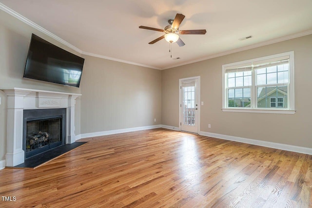 996 Tender Dr, Apex, NC 27502 - unfurnished living room with wood finished floors, a fireplace, a ceiling fan, and crown molding