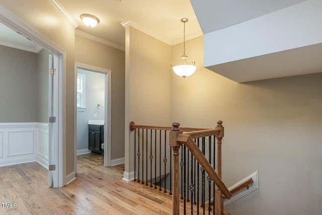 996 Tender Dr, Apex, NC 27502 - hall featuring an upstairs landing, light wood-style flooring, and crown molding