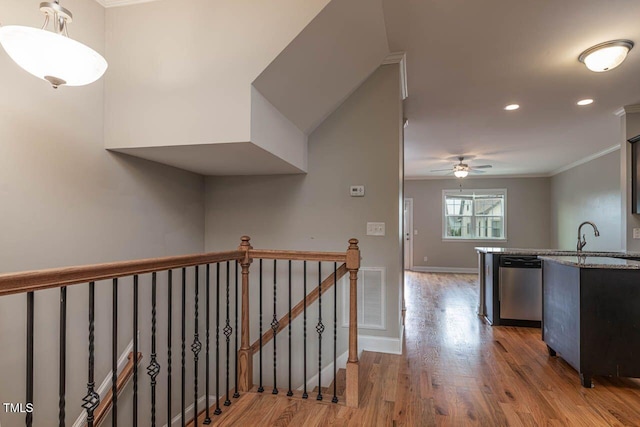 996 Tender Dr, Apex, NC 27502 - hallway featuring ornamental molding, wood finished floors, an upstairs landing, and recessed lighting