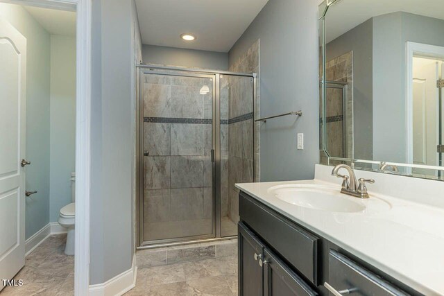 996 Tender Dr, Apex, NC 27502 - bathroom featuring vanity, a stall shower, and recessed lighting