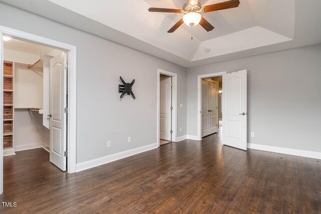 996 Tender Dr, Apex, NC 27502 - spare room featuring ceiling fan, a raised ceiling, and wood finished floors