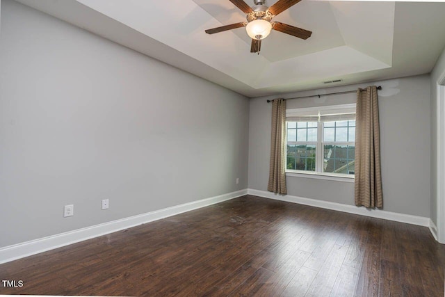 996 Tender Dr, Apex, NC 27502 - spare room featuring a raised ceiling, a ceiling fan, and hardwood / wood-style flooring