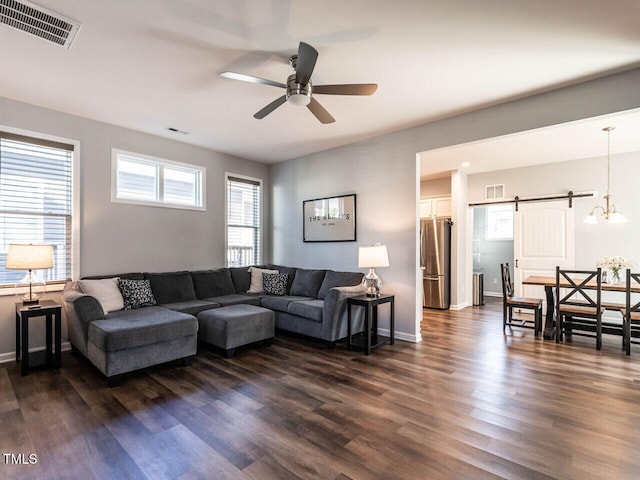 157 E Wilson St, Clayton, NC 27520 - living room with a barn door, a ceiling fan, and dark wood-type flooring