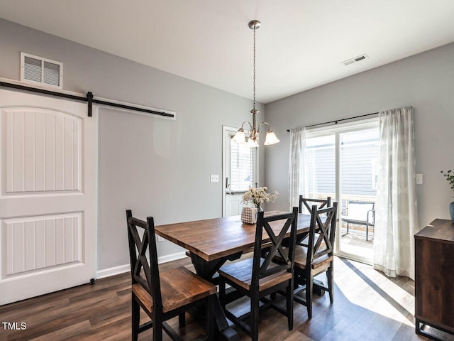 157 E Wilson St, Clayton, NC 27520 - dining area with dark wood-type flooring, a chandelier, and a barn door