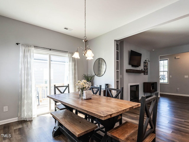 157 E Wilson St, Clayton, NC 27520 - dining space with dark wood-type flooring and a chandelier