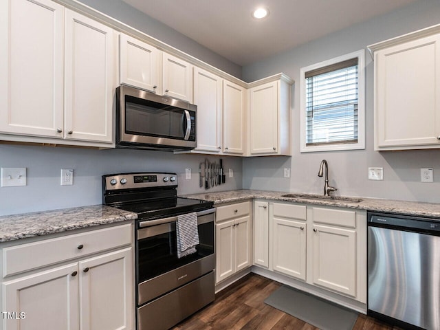 157 E Wilson St, Clayton, NC 27520 - kitchen featuring appliances with stainless steel finishes, dark wood finished floors, white cabinets, and recessed lighting