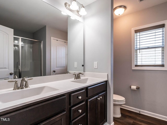 157 E Wilson St, Clayton, NC 27520 - full bath featuring double vanity, a stall shower, and wood finished floors