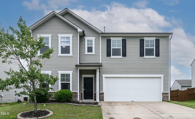 8005 Caithness St, Raleigh, NC 27616 - view of front of home featuring stone siding, driveway, and an attached garage