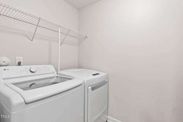 8005 Caithness St, Raleigh, NC 27616 - washroom with washing machine and dryer and baseboards