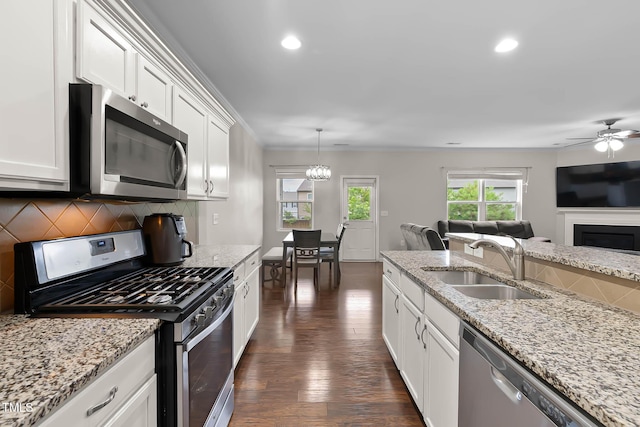 8005 Caithness St, Raleigh, NC 27616 - kitchen with appliances with stainless steel finishes, dark wood finished floors, white cabinetry, recessed lighting, and tasteful backsplash
