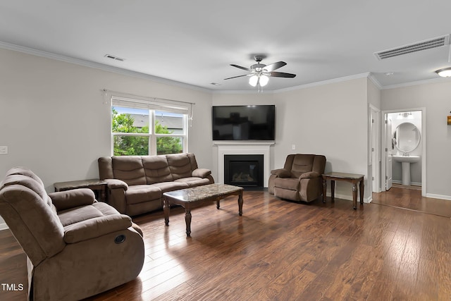 8005 Caithness St, Raleigh, NC 27616 - living area with ceiling fan, dark wood-type flooring, ornamental molding, and a glass covered fireplace