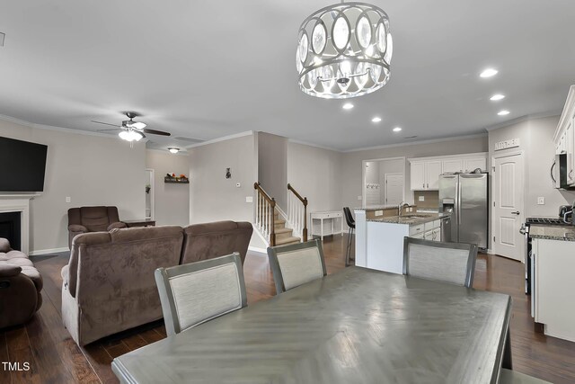 8005 Caithness St, Raleigh, NC 27616 - dining space with ornamental molding, recessed lighting, ceiling fan, dark wood finished floors, and stairway