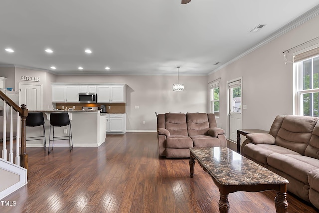 8005 Caithness St, Raleigh, NC 27616 - living area featuring ornamental molding, dark wood finished floors, recessed lighting, and stairway